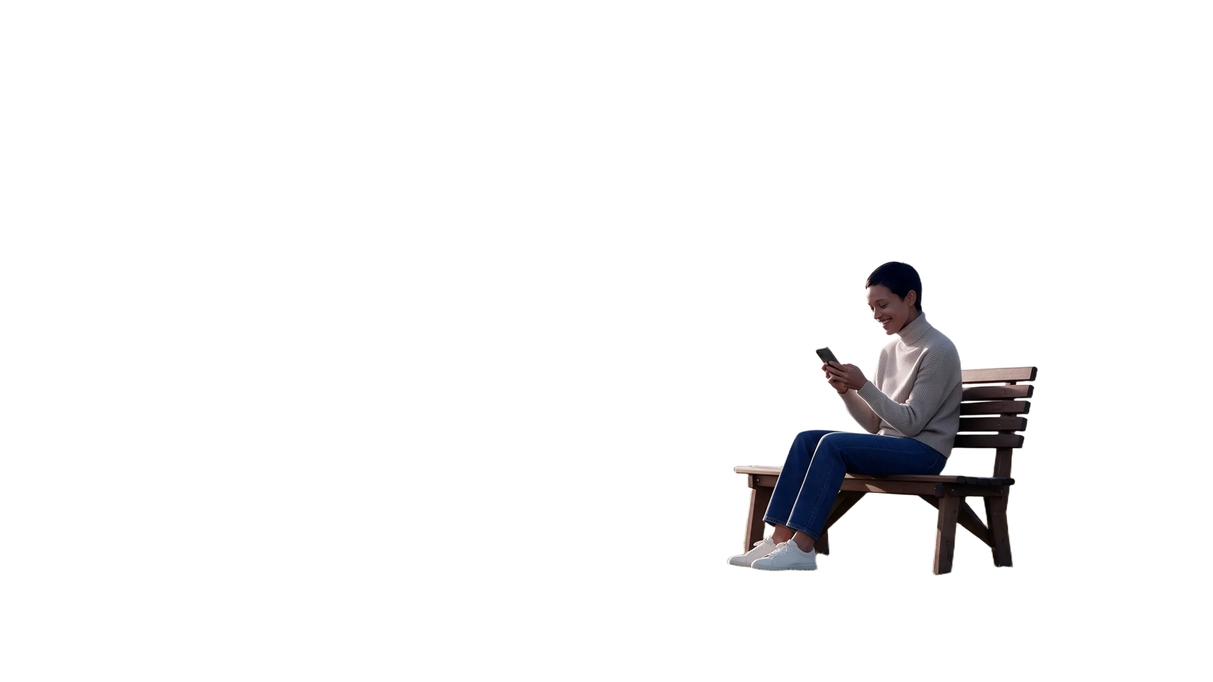 A woman on a park bench, smiling at her phone.